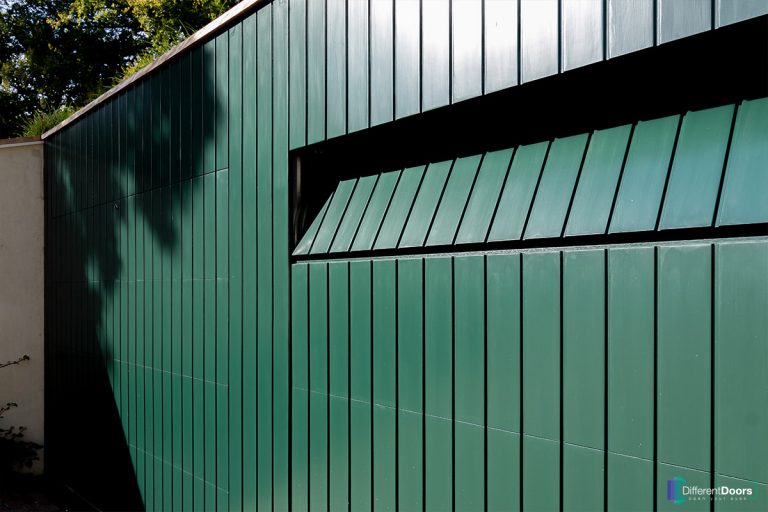 Houten sectionaaldeur gelijk met de gevel groen